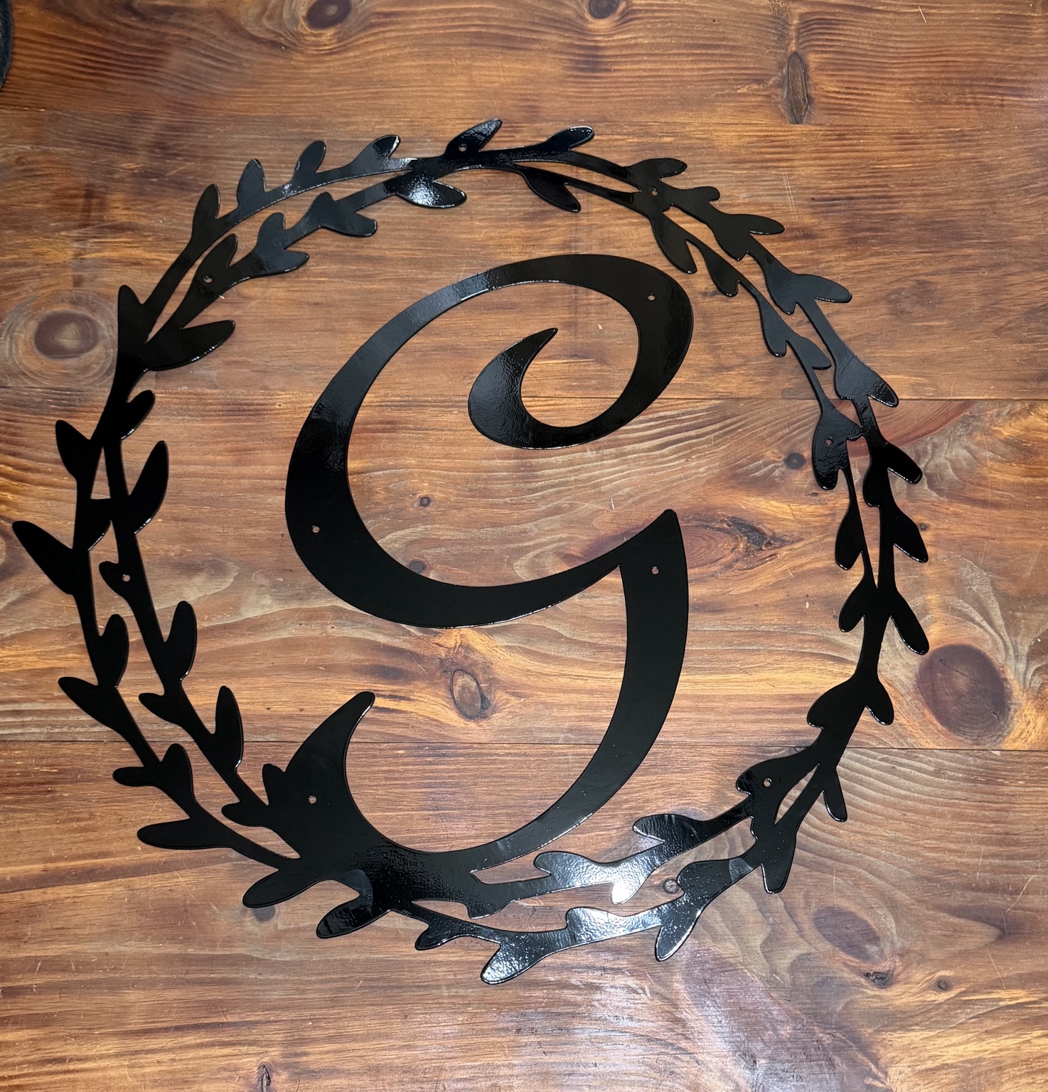 Black powder-coated floral monogram metal sign