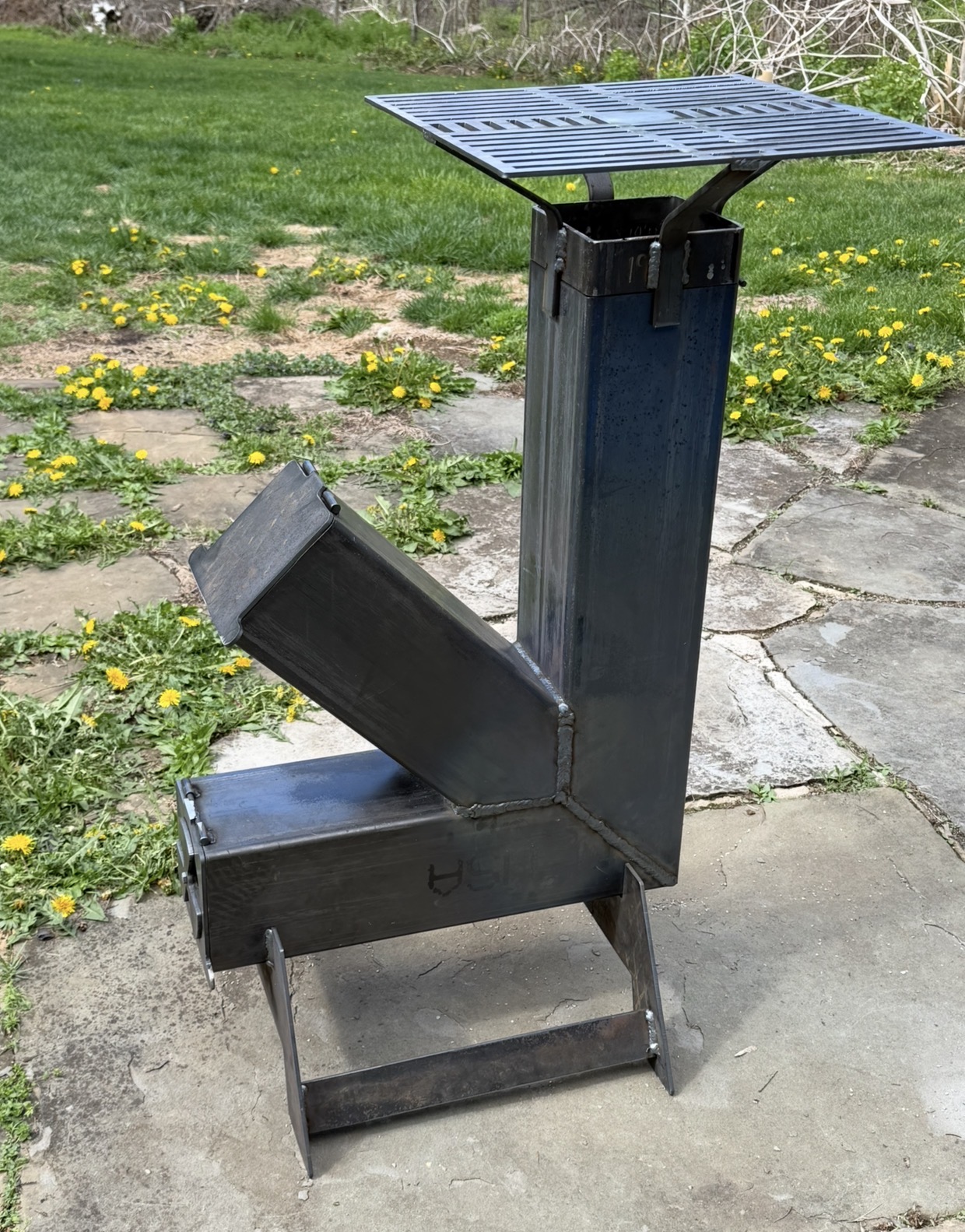 Custom-built rocket stove with removable cooking grate